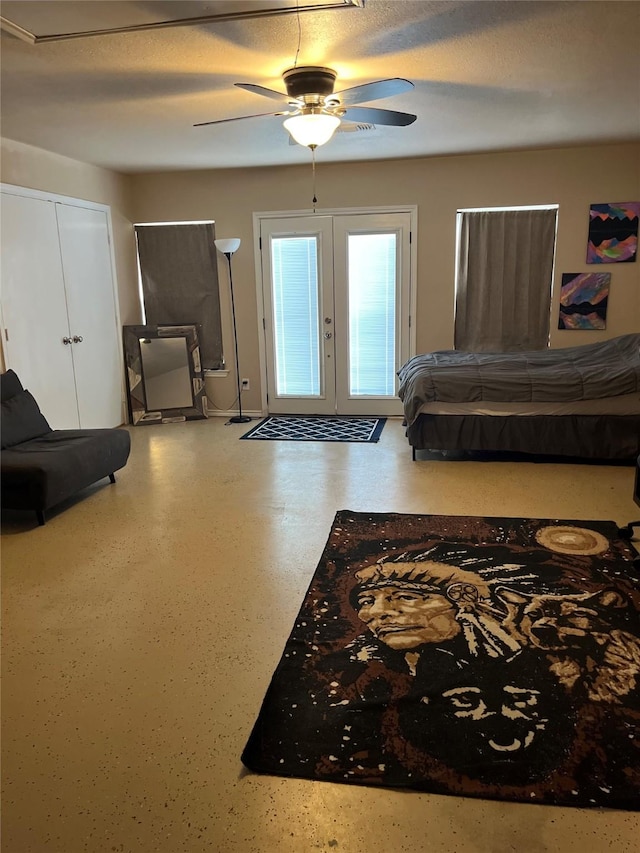 bedroom with ceiling fan, a textured ceiling, and french doors