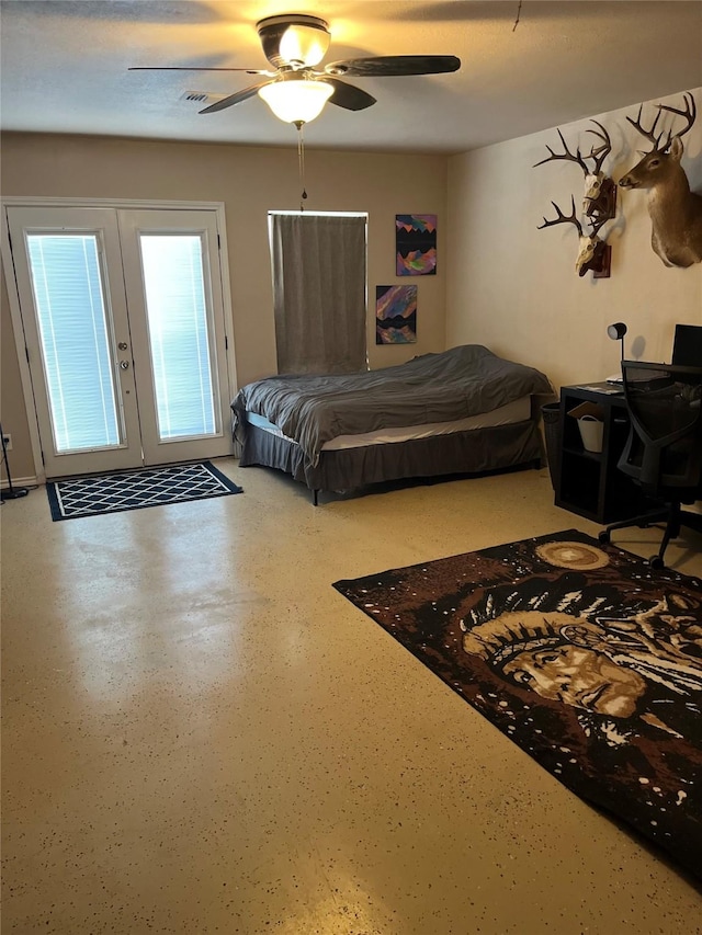 bedroom with ceiling fan, french doors, and a textured ceiling