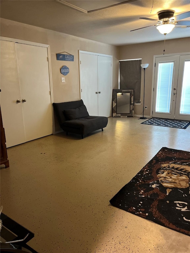 entrance foyer featuring ceiling fan, french doors, and a textured ceiling