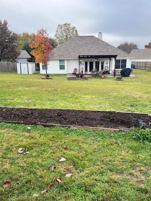 view of yard with a patio area and a storage shed