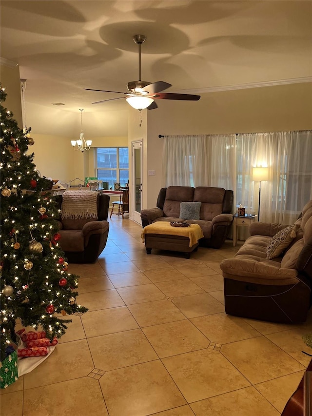 tiled living room with ceiling fan with notable chandelier