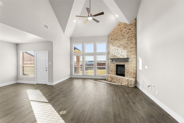 unfurnished living room with dark wood-style floors, high vaulted ceiling, a fireplace, and visible vents