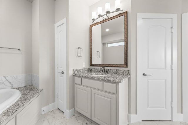 bathroom featuring marble finish floor, baseboards, and vanity