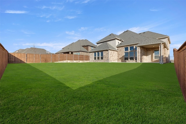 view of yard with a fenced backyard