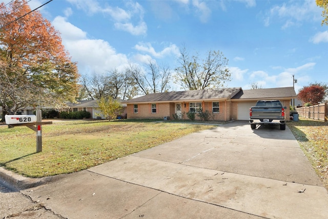 ranch-style house with a garage and a front yard