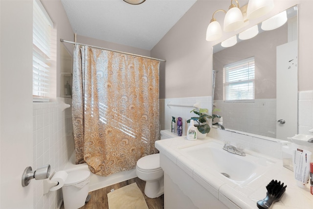 full bathroom with toilet, shower / tub combo with curtain, vanity, tile walls, and hardwood / wood-style flooring