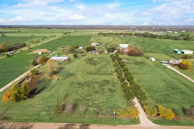 birds eye view of property with a rural view