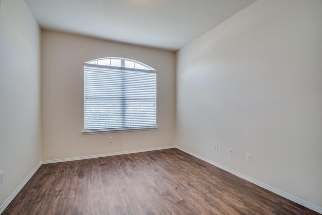 spare room featuring dark hardwood / wood-style floors