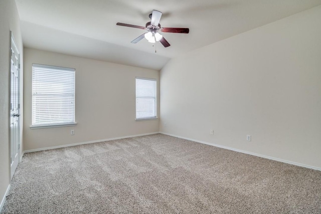 unfurnished room with light carpet, plenty of natural light, and vaulted ceiling