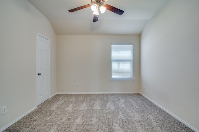 carpeted spare room featuring ceiling fan and lofted ceiling