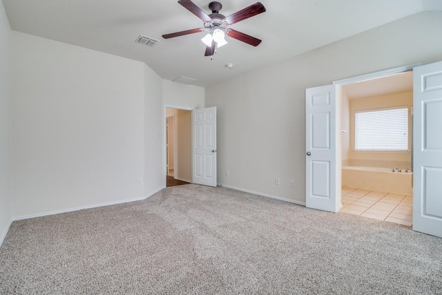 unfurnished bedroom with ceiling fan, light carpet, and ensuite bath