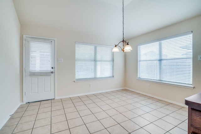 unfurnished dining area with light tile patterned flooring and a notable chandelier