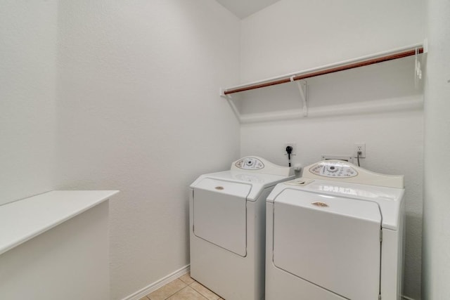 laundry room featuring independent washer and dryer and light tile patterned floors