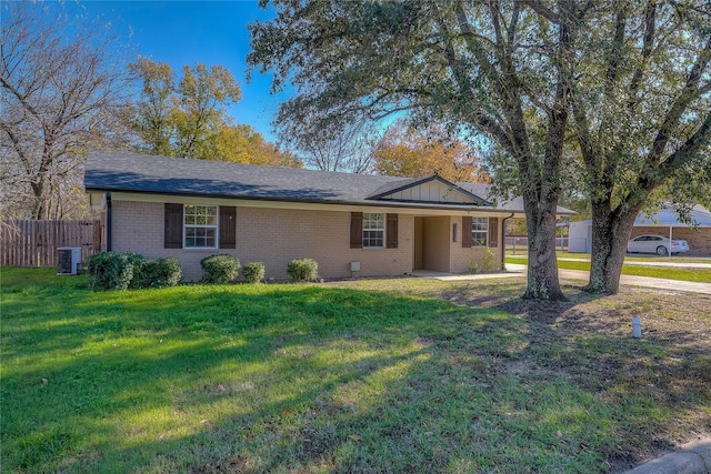 single story home featuring central air condition unit and a front yard