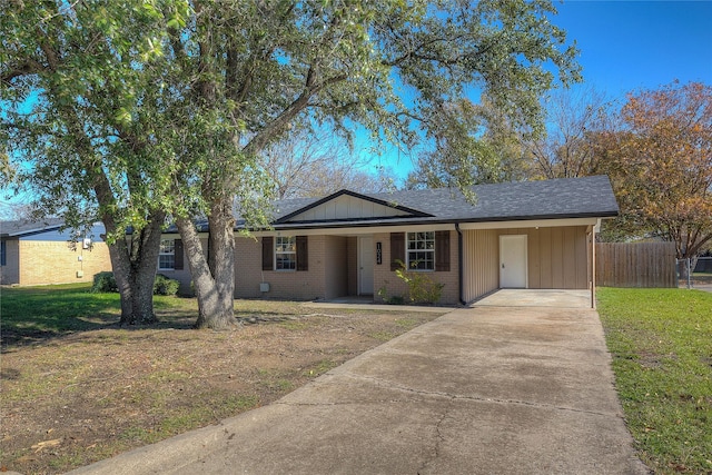 ranch-style house with a front yard and a carport