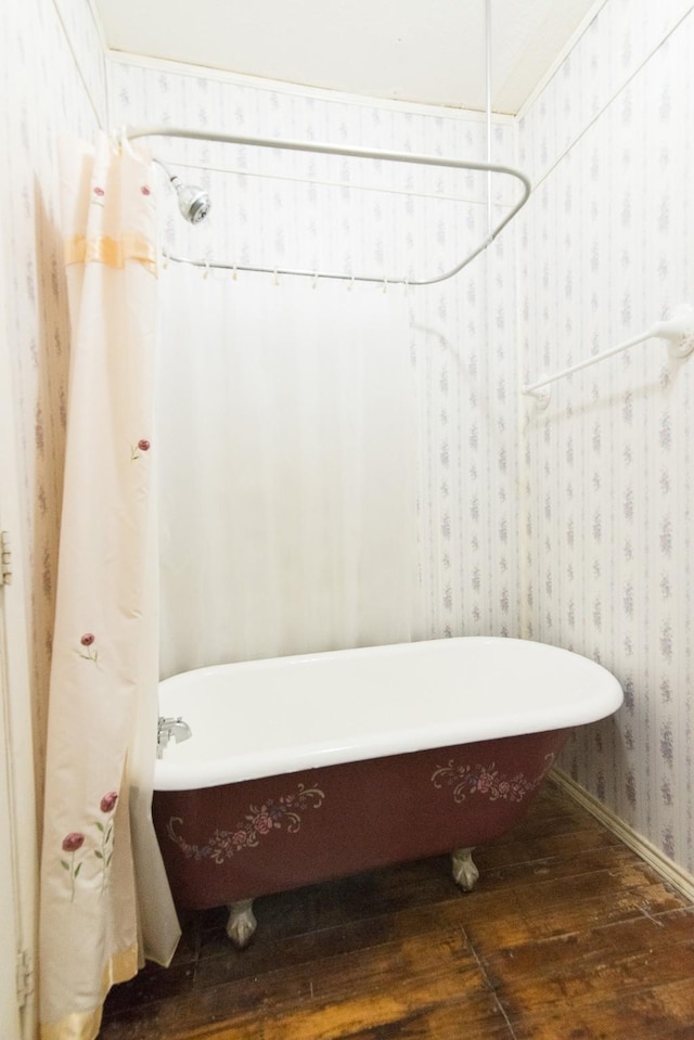 bathroom with hardwood / wood-style floors and a bathtub