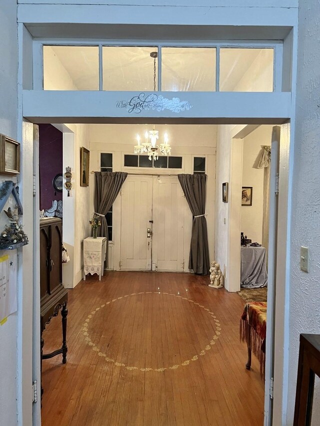 interior space featuring hardwood / wood-style floors and an inviting chandelier