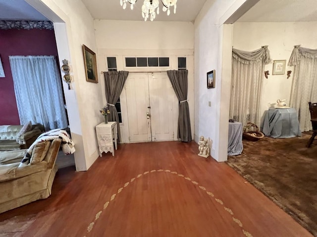 entryway featuring hardwood / wood-style floors and a notable chandelier