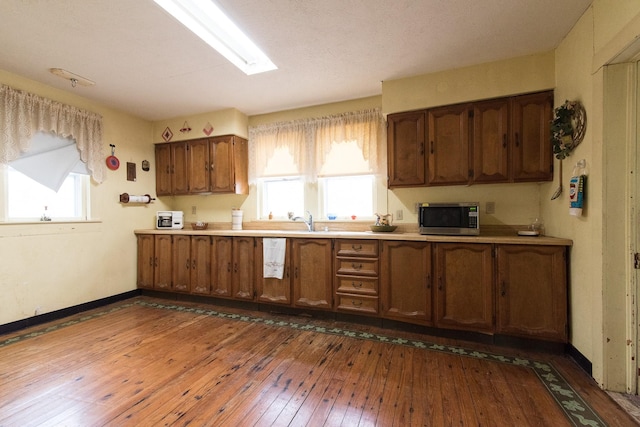 kitchen featuring hardwood / wood-style flooring, plenty of natural light, and sink