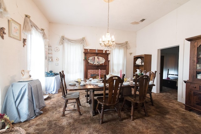 dining room with dark carpet and an inviting chandelier