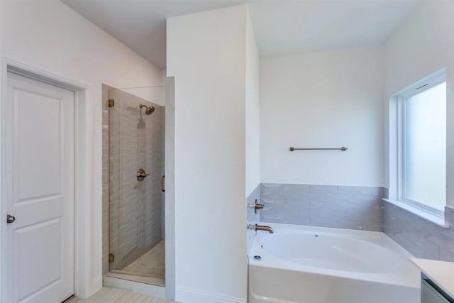 bathroom with a stall shower, vanity, and a bath