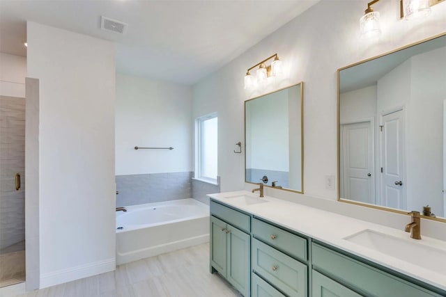 full bathroom with a stall shower, visible vents, a sink, and a bath