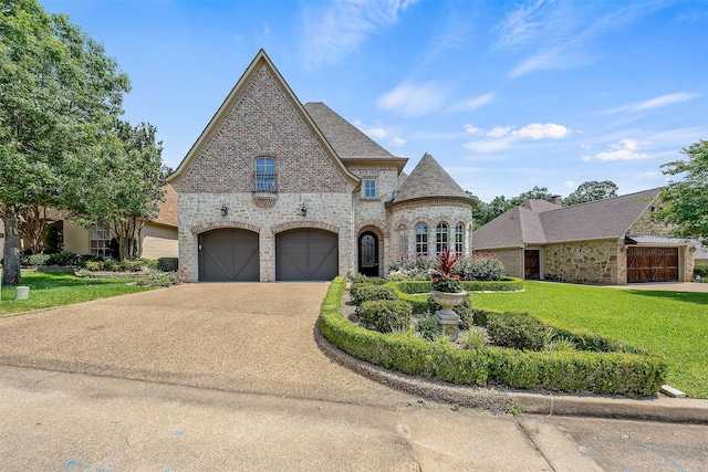 french country inspired facade featuring a garage and a front lawn