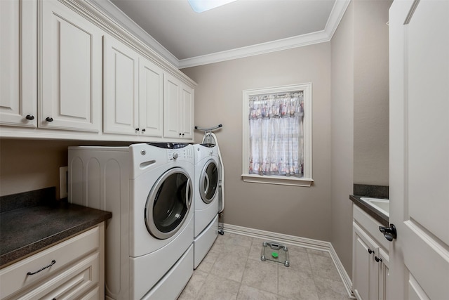 laundry room featuring cabinets, washing machine and dryer, light tile patterned floors, and crown molding