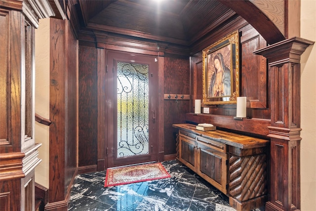 foyer entrance featuring crown molding, arched walkways, and wooden walls