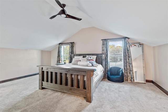 bedroom with multiple windows, ceiling fan, and light colored carpet