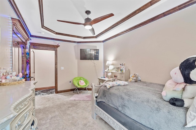 bedroom featuring ceiling fan, a raised ceiling, crown molding, and light carpet