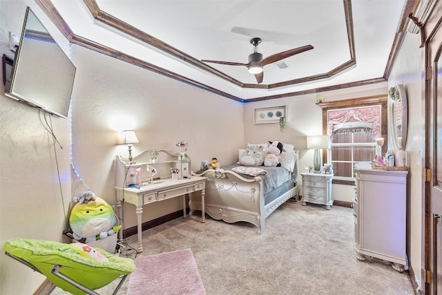 bedroom with crown molding, ceiling fan, a tray ceiling, and light colored carpet