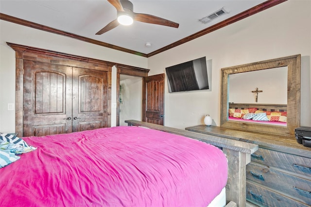 bedroom with ceiling fan, a closet, and ornamental molding