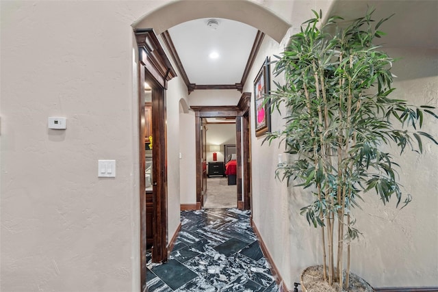 hallway featuring ornamental molding