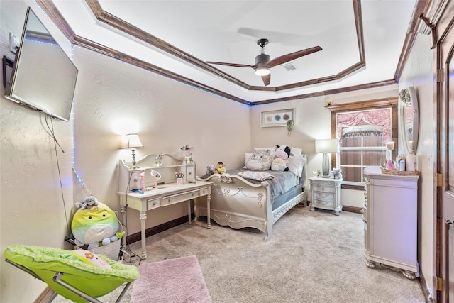 bedroom with a tray ceiling, ceiling fan, crown molding, and light colored carpet