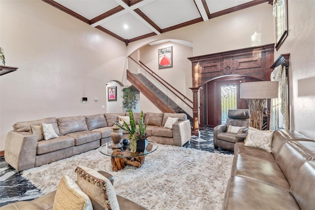 living room featuring beam ceiling, coffered ceiling, and ornamental molding