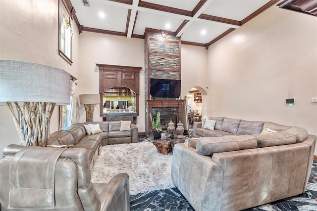 living room featuring beam ceiling, a towering ceiling, crown molding, and coffered ceiling