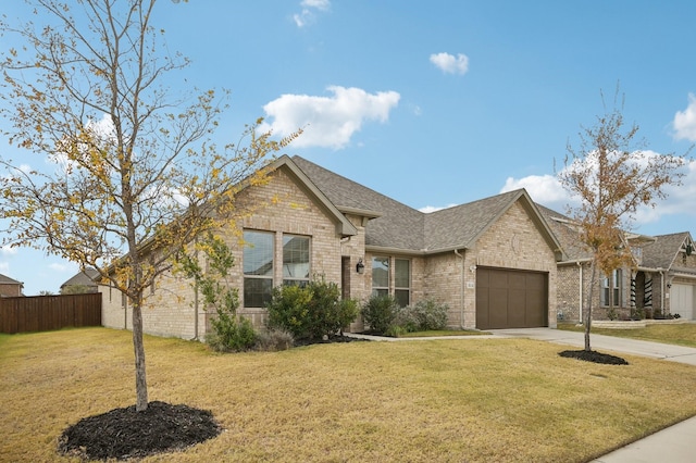 view of front of home featuring a garage and a front lawn