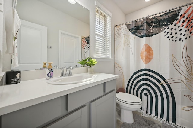 bathroom with vanity, toilet, and walk in shower