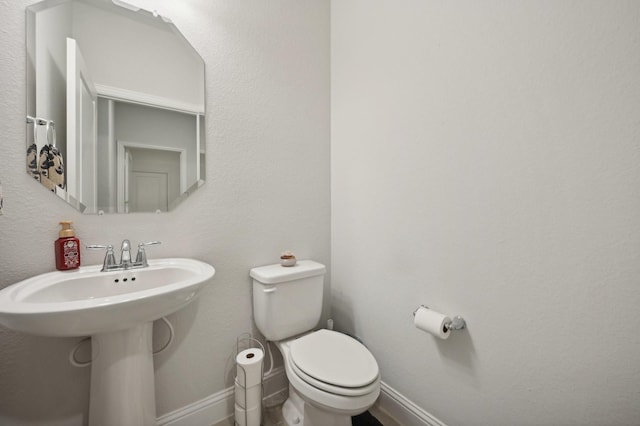 bathroom with toilet and sink