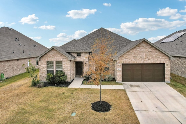 view of front facade with a garage and a front lawn