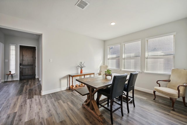 dining area with dark hardwood / wood-style flooring