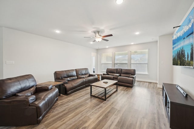 living room featuring ceiling fan and light wood-type flooring