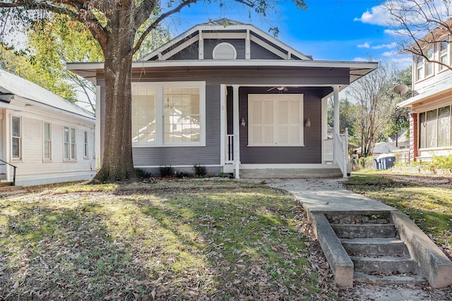 bungalow-style house with a porch, a front lawn, and ceiling fan