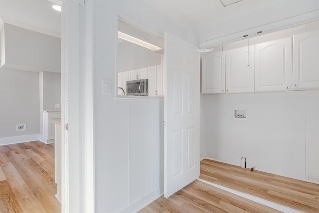 laundry room featuring cabinets, washer hookup, light wood-type flooring, and ornamental molding