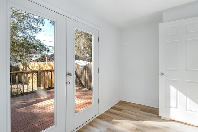 doorway to outside featuring french doors and light wood-type flooring