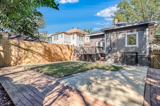 rear view of house featuring a deck and a yard