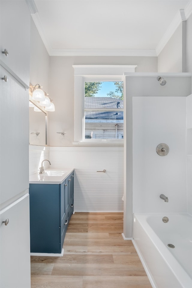 bathroom featuring crown molding, wood-type flooring, shower / bath combination, and vanity