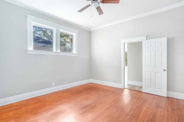 spare room featuring hardwood / wood-style flooring, crown molding, and ceiling fan