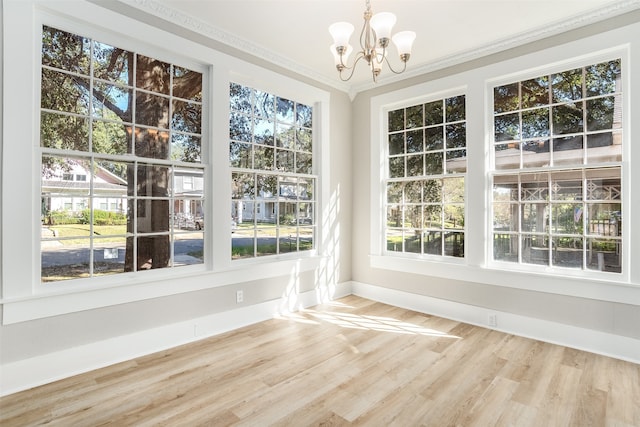 unfurnished sunroom with a healthy amount of sunlight and a chandelier